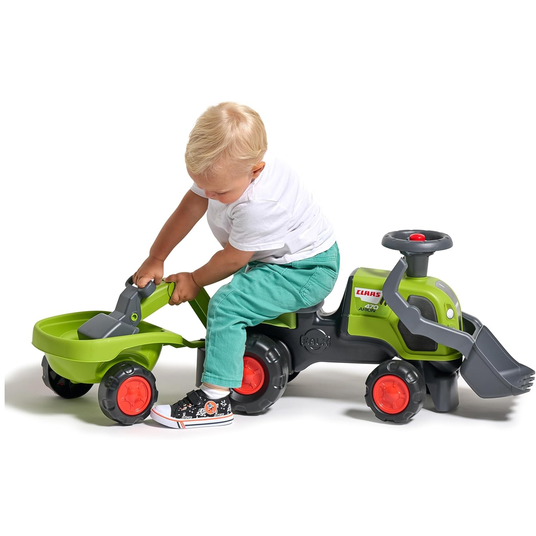 FALK Baby Claas-ajotraktori, jossa on kaivinkoneen kauha ja perävaunu.