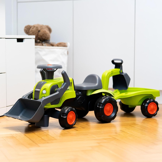 FALK Baby Claas-ajotraktori, jossa on kaivinkoneen kauha ja perävaunu.